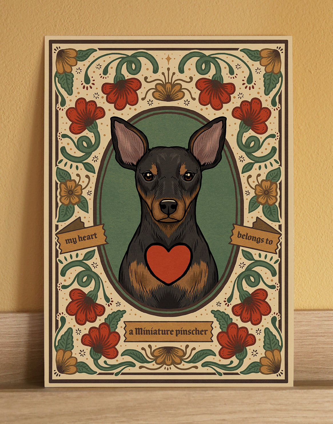 Miniature Pinscher fine art print, with a decorative floral border in warm tones. A cute gift for a pet lover